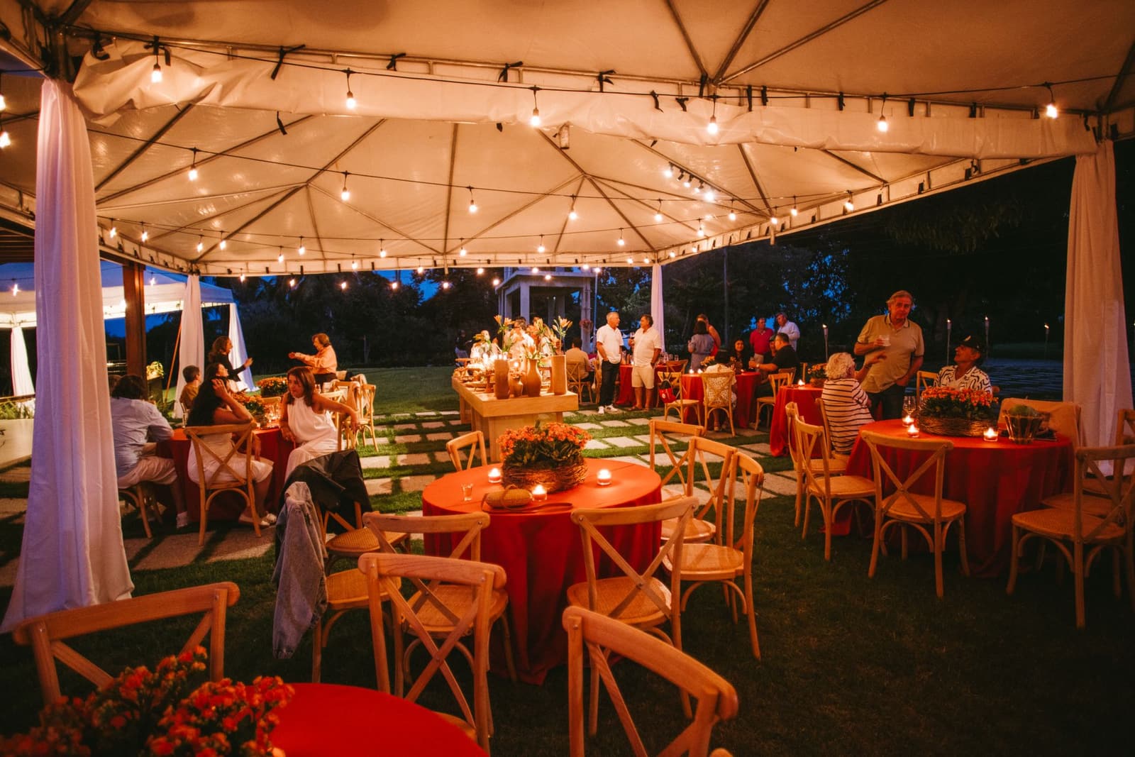 Outdoor evening event set up with string lights and seating