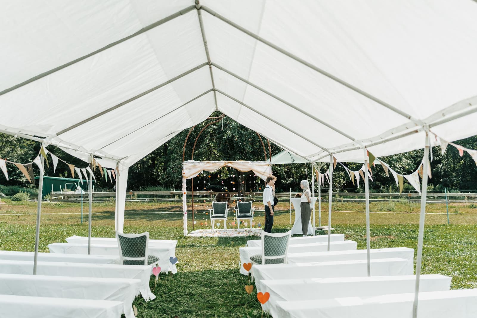 White marquee set up for an outdoor wedding reception